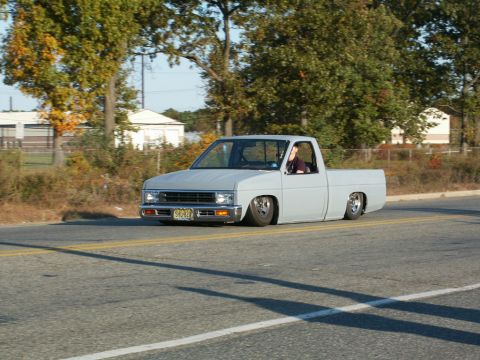 2001 Mercury Grand Marquis - A light-colored pickup truck with a lowered suspension is seen driving on a road.