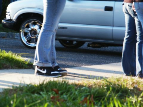 2001 Mercury Grand Marquis - A silver pickup truck with custom chrome wheels is seen from the side, with people standing nearby.
