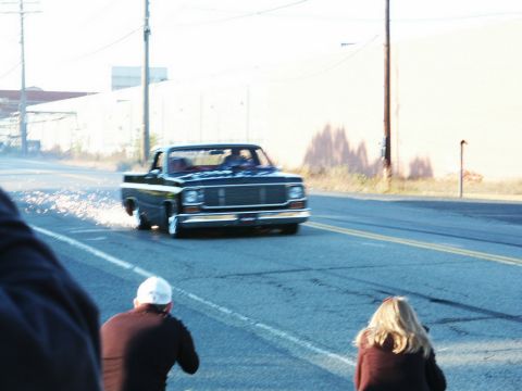2001 Mercury Grand Marquis - A pickup truck is seen performing a burnout on a street, with sparks flying from its tires.