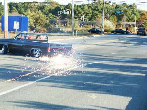 2001 Mercury Grand Marquis - Pickup truck performing a burnout at an intersection, creating a shower of sparks.