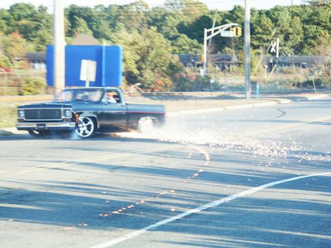 2001 Mercury Grand Marquis - A pickup truck performs a burnout, creating a shower of sparks on the asphalt.