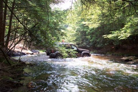 2001 Ford Escape - A neat place to do a water crossing, but with stock street tires, those wet rocks would go through like a hot knife though butter, so we di…