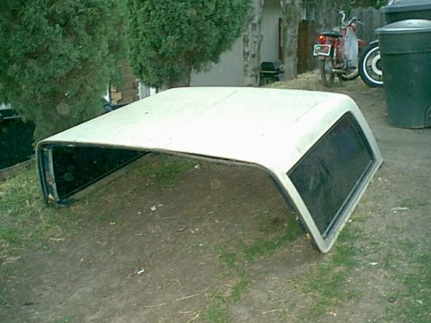 1983 Ford Bronco - the top is not too heavy- it is bulky and 1 person can pull it but 2 make it real nice. here it is on the grass at this time.