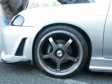 2001 Mercury Grand Marquis - Close-up of a customized car wheel, showing aftermarket rims and brake calipers.