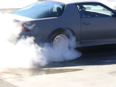 1991 Ford Probe - Car performing a burnout, generating significant tire smoke. Scott Taylor's name is visible on the door.