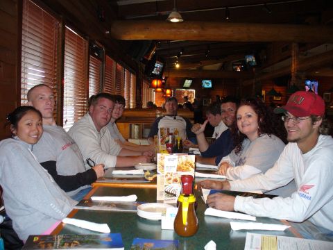 1991 Ford Probe - People gathered around a table at a restaurant, enjoying a meal together.