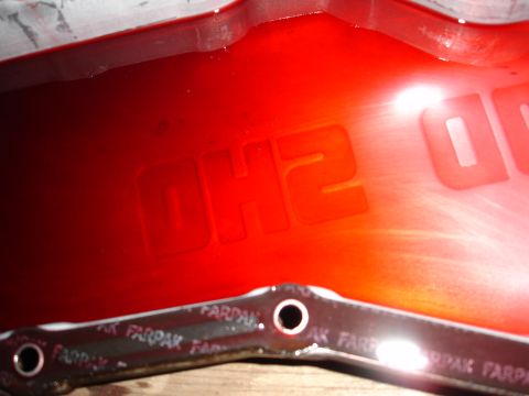 1993 Ford Taurus - Transmission pan with red fluid and embossed text 'OH2'. Gasket is visible.