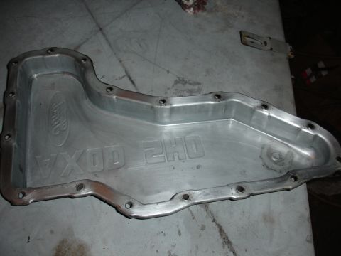 1993 Ford Taurus - An aluminum oil pan with Ford branding and embossed text is shown.