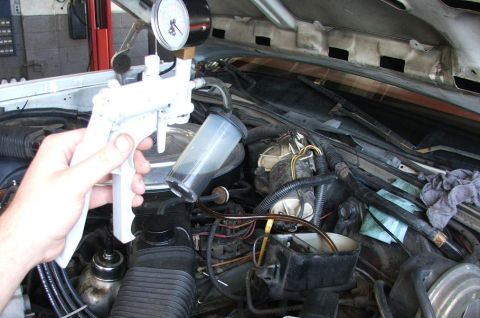1985 Ford Crown Victoria LTD - Brake bleeder tool in use on a 1985 Ford Crown Victoria LTD engine.