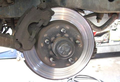 1985 Ford Crown Victoria LTD - Close-up view of a vehicle's brake rotor and caliper.