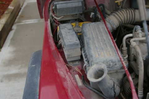 1998 Jeep TJ - Engine bay components of a 1998 Jeep TJ, including fuse box and air intake.