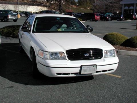 1998 Ford Crown Victoria - Front view of a white 1998 Ford Crown Victoria parked in a lot.