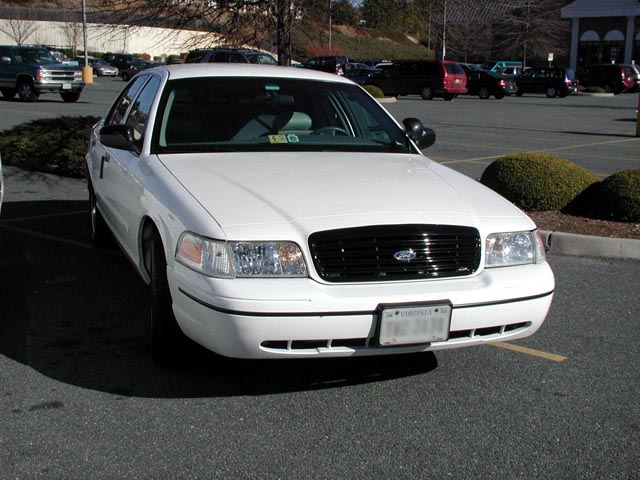 White Ford Crown Victoria sedan front three-quarter view with Virginia plate
