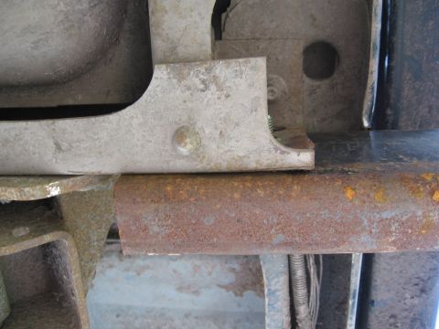 1974 Ford F-100 - Close-up view of rusted metal frame and bumper bracket components.