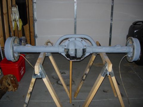 1995 Ford Bronco - A rear axle assembly, likely for a truck or SUV, is shown on sawhorses in a garage setting.