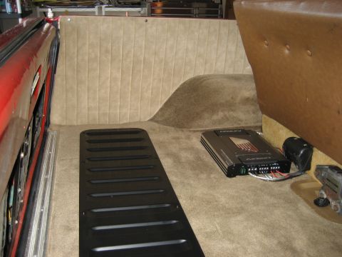 1979 Ford Bronco - Interior view of a vehicle's rear cargo area with an aftermarket audio amplifier installed.