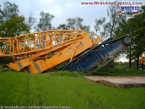 1996 Ford F-150 - A large crane has collapsed onto its side in a field, with its boom and tracks visible.
