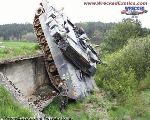1996 Ford F-150 - A military tank is stuck in a ditch, with a soldier standing next to it.