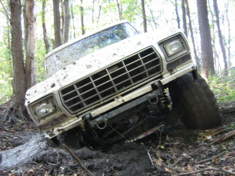 1990 Ford Bronco - This 1978 Ford Bronco is stuck in the mud while off-roading through a wooded area.