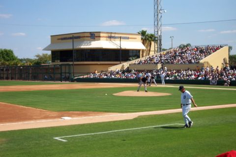 1979 Ford F-150 - A baseball game is underway at a stadium with a large crowd in the stands.