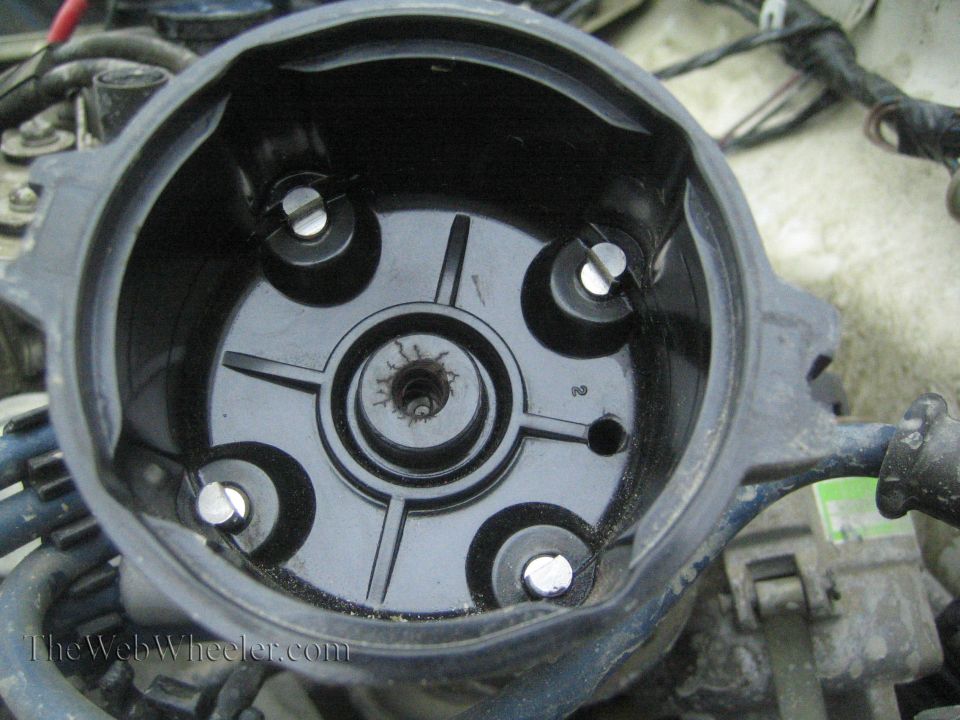 Distributor cap interior with four spark plug wire terminals visible