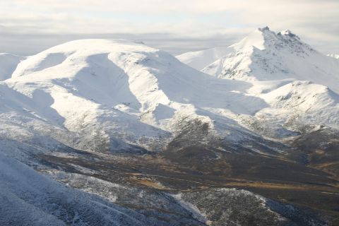 2003 Jeep TJ - Expansive view of snow-covered mountain ranges under a cloudy sky.