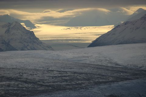 2003 Jeep TJ - A vast, icy landscape unfolds under a dramatic sky, with snow-capped peaks and glaciers stretching into the distance.