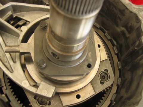 1992 Ford Bronco - Close-up of a disassembled automatic transmission showing internal components including a splined input shaft, planetary gear assembly, clu…