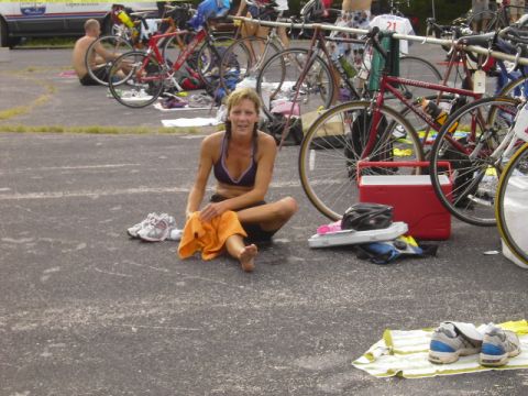1991 Ford Bronco - A participant rests with a towel after a race, surrounded by bicycles and gear.