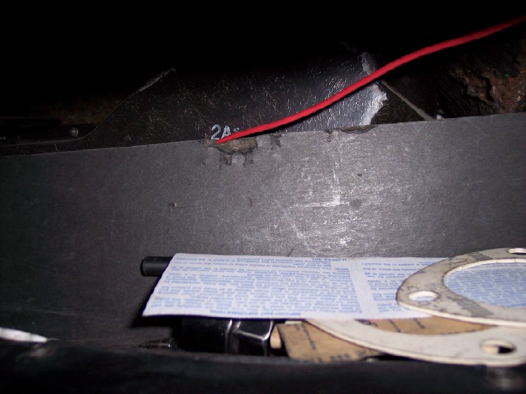 Interior compartment with red wire, document, and gaskets