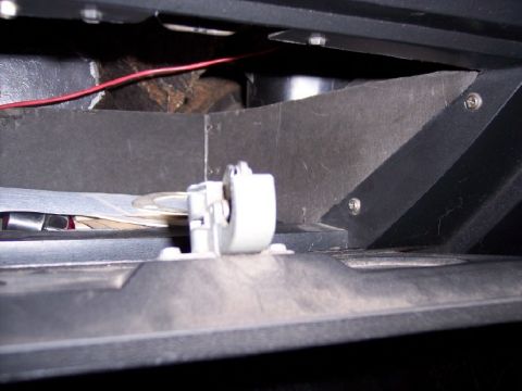 1972 Ford Ranchero - Close-up view of the inside of a vehicle's glove compartment, revealing a latch and stored items.