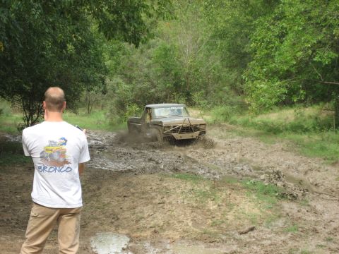1986 Ford Bronco - Ford F-Series truck navigating a challenging mud obstacle.