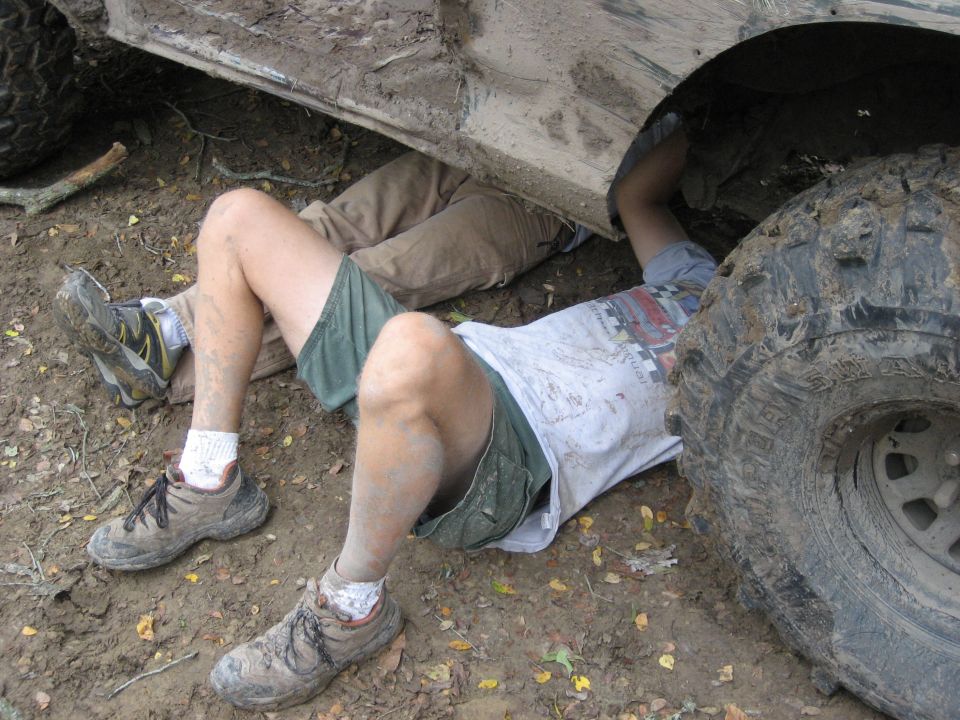 under the truck diagnosing the damage after the break on the hill climb