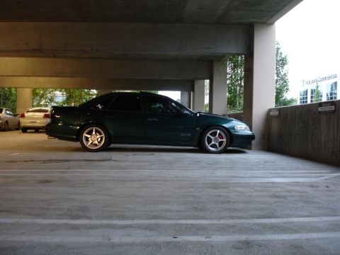 1993 Ford Taurus - Side profile of a 1993 Ford Taurus in a parking garage. Another vehicle is parked behind it.