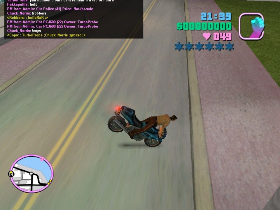 Motorcycle doing a wheelie on a road, with game UI elements visible