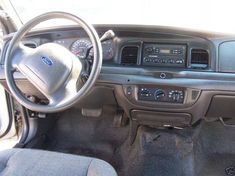 2003 Ford Crown Victoria - The interior of a 2003 Ford Crown Victoria, viewed from the passenger side, displays the driver's side dashboard and controls.
