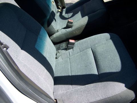 2003 Ford Crown Victoria - Close-up view of the interior seats and seatbelts of a vehicle.