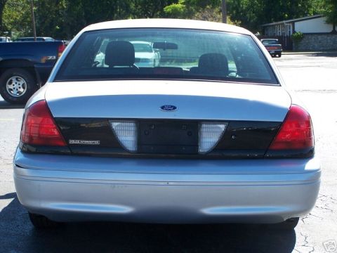 2003 Ford Crown Victoria - Rear view of a silver 2003 Ford Crown Victoria Police Interceptor with a black accent panel between the taillights.