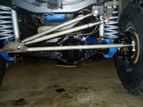 1969 Ford Bronco - Close-up view of a vehicle's suspension and drivetrain components, showing modifications and aftermarket parts.
