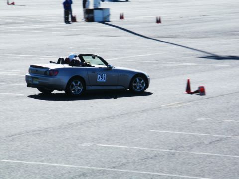 2001 Mercury Grand Marquis - A silver convertible sports car navigates a course marked by traffic cones on a sunny day.