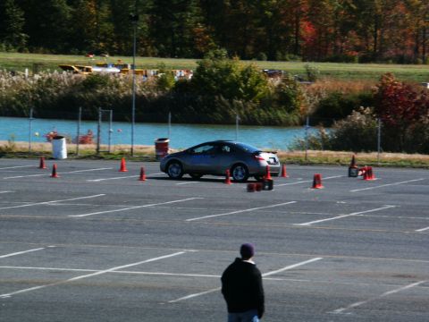 2001 Mercury Grand Marquis - A silver coupe navigates a cone course near a body of water.