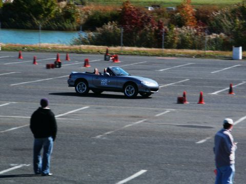 2001 Mercury Grand Marquis - A silver convertible sports car, marked with '558', navigates a cone course on a sunny day.