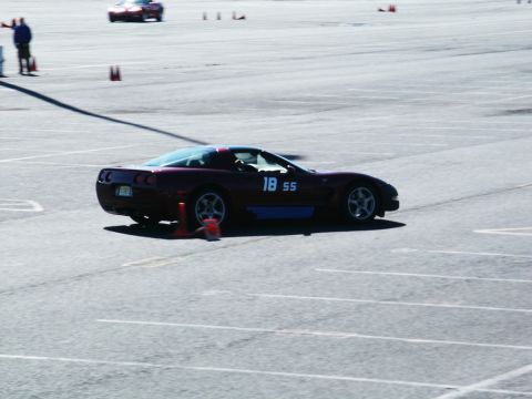 2001 Mercury Grand Marquis - A Chevrolet Corvette participates in a track event, with another car in the distance.