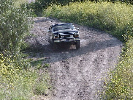 1981 Ford Bronco - My bronco jumping out of a mud hole. Look at the drivers front tire launching off the ground.