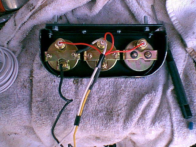 This is the back side of the aftermarket guages. I got this set from Pep Boys $20. The connections are easy. the lights need a ground and a panel hot ( i used the ashtray light wire. the water is a probe that goes into the water jacket and the oil on the pressure line and the volts to a POS battery connection.