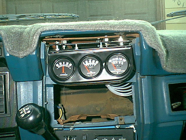 this was setting up the next step. the guages are just in place not completly installed. i wanted to see how level it looked and run the needed wires and tubes. you can see this dash was beatup. (i was installing a 1987 ac systen to replace the mess that was there this is in the other folder).