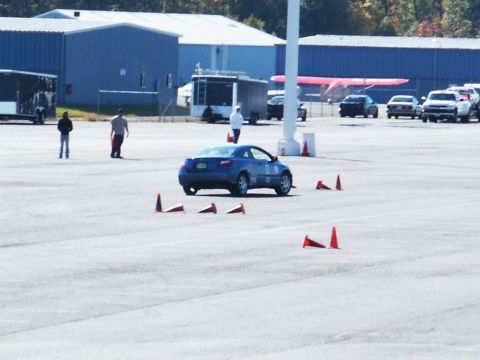 2001 Mercury Grand Marquis - A blue coupe is seen on a track, maneuvering through orange cones during what appears to be a timed event.