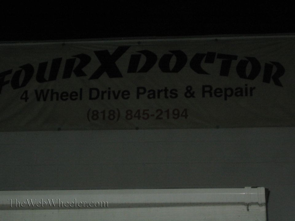 Four X Doctor 4-wheel-drive parts and repair shop banner sign