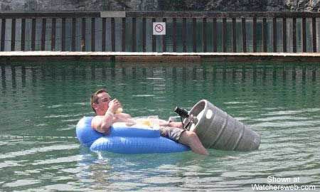 1991 Ford Bronco - A man relaxes on an inflatable raft with a keg, enjoying a drink in the water.