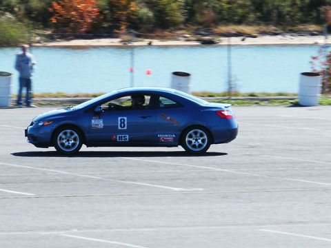 2001 Mercury Grand Marquis - A blue Honda coupe with racing decals and the number 8 is seen on a track.